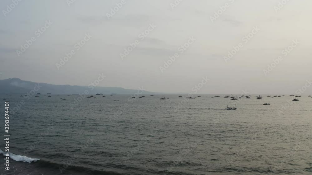 Many small ships seen out at sea from beach, Indonesia, Panning right Many small ships seen out at sea from beach, Indonesia, Panning right