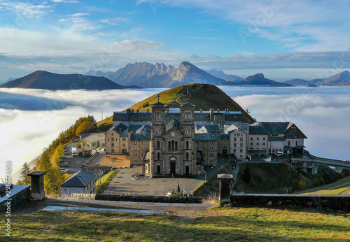 Shrine of Our Lady La Salette above the clouds. Sanctuary in the town of La Salette-Fallavaux in the Provence-Alpes-Côte d'Azur. Hautes-Alpes, French Alps, France