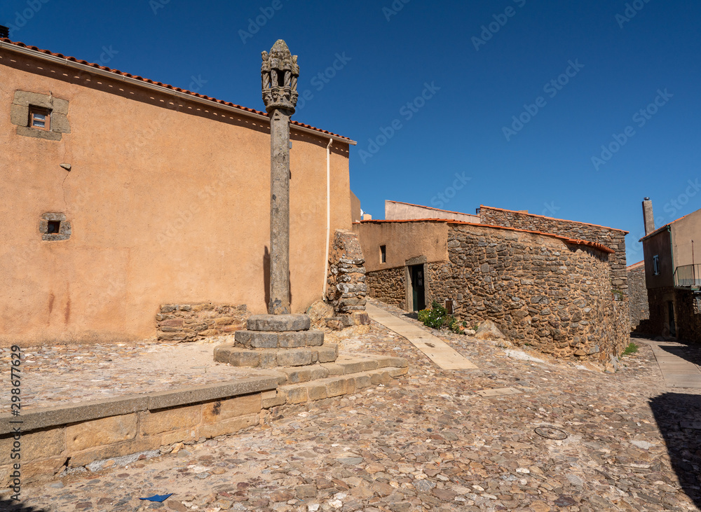 Old carved stone pillory column by narrow streets in the ancient town of Castelo Rodrigo in Portugal Old carved stone pillory column by narrow streets in the ancient town of Castelo Rodrigo in Portugal