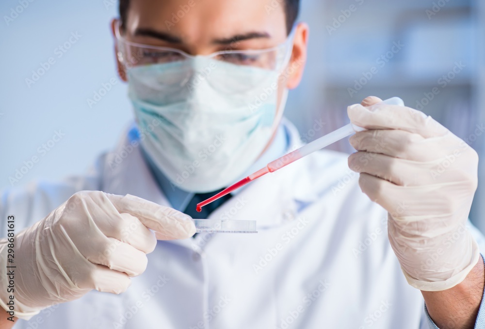 Lab assistant testing blood samples in hospital Lab assistant testing blood samples in hospital
