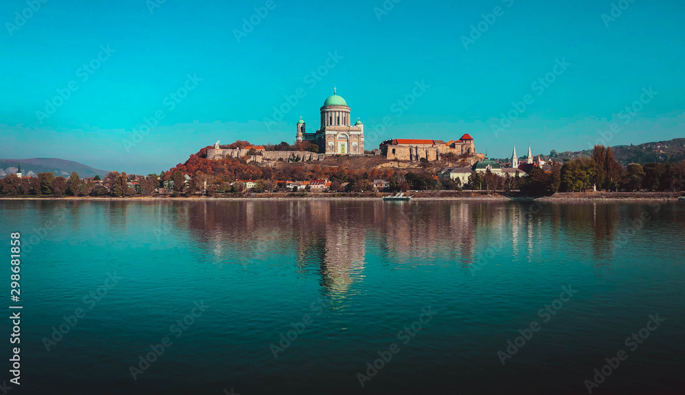 Aerial view of the Esztergom Basilica and and the Castle Museum in Esztergom, Hungary. Amazing view over Danube river, beautiful reflections mirrored in water. Panoramic landscape photo.