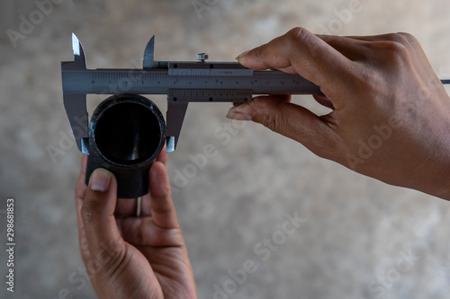 Using Vernier caliper to measure the dimensions outside diameter of the Elbow Pipe Fittings. photo