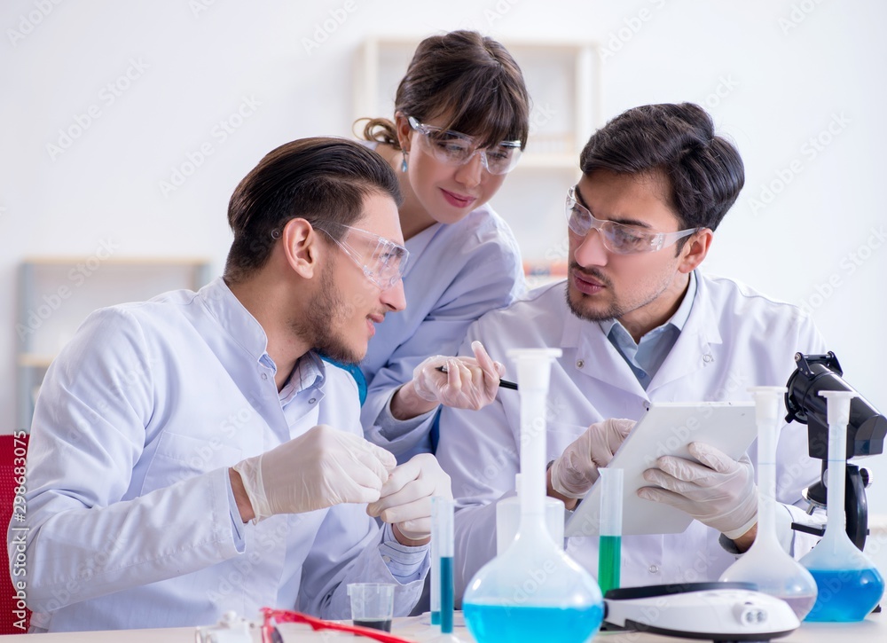 Team of chemists working in the lab Team of chemists working in the lab