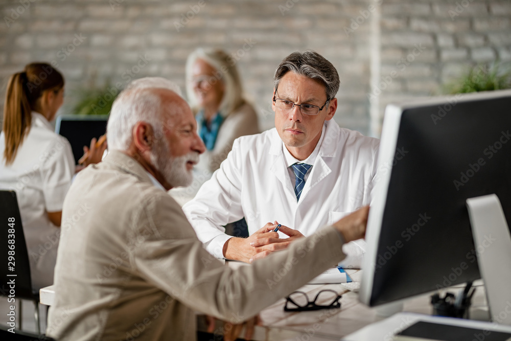 Male doctor having consultations with senior man at clinic. Male doctor having consultations with senior man at clinic.