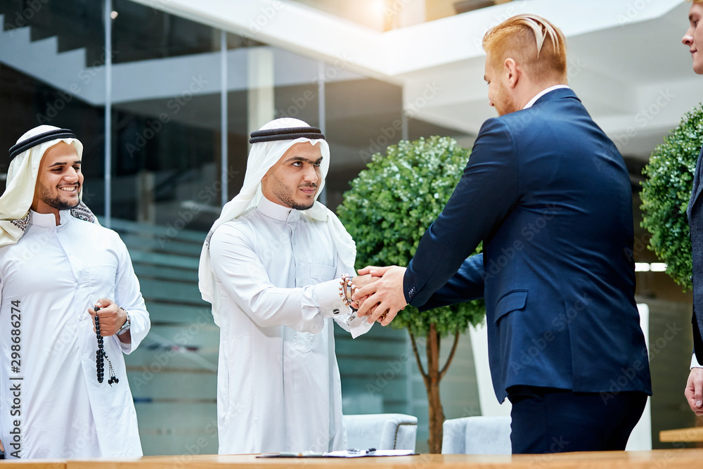 business, technology and office concept. Welcome, greeting each other at business meeting business, technology and office concept. Welcome, greeting each other at business meeting