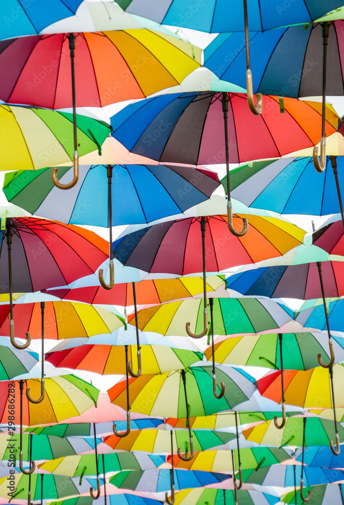 a collection of open umbrellas floating in the air, each umbrella is painted in all colors of the rainbow, photographed from below a collection of open umbrellas floating in the air, each umbrella is painted in all colors of the rainbow, photographed from below
