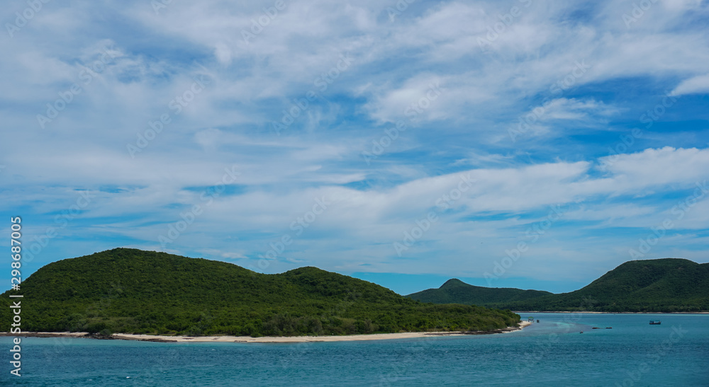 Mountains in the sea with bright sky.