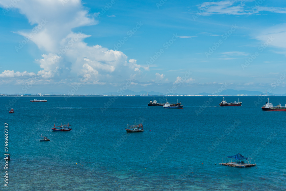 Fishing boats floating in the sea with blue sky