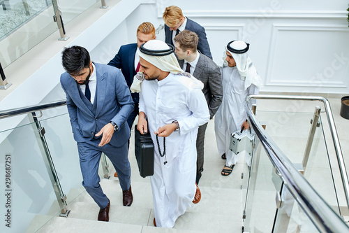 Photography Sheikh holding black case and speak. Rich men make business deal