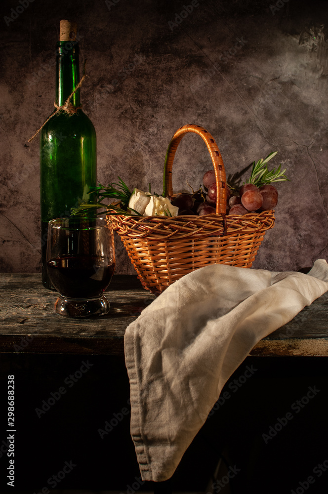 Still life bread in basket and bottle of wine. on a wooden basis Still life bread in basket and bottle of wine. on a wooden basis