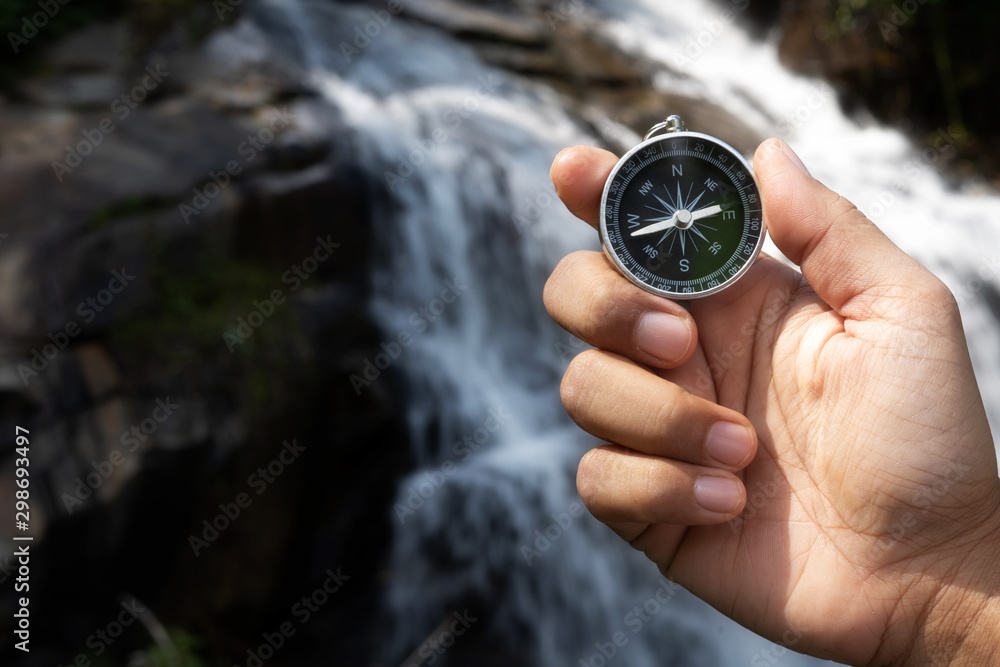  man hold compass in nature background for journey trip