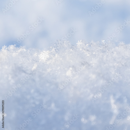 Background of fresh snow. Natural winter background. Snow texture in blue tone © OLAYOLA