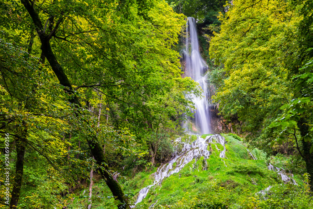 Germany, Impressive 37m high waterfall of climatic spa region in green forest of bad urach in swabian jura nature landscape, a popular tourist attraction