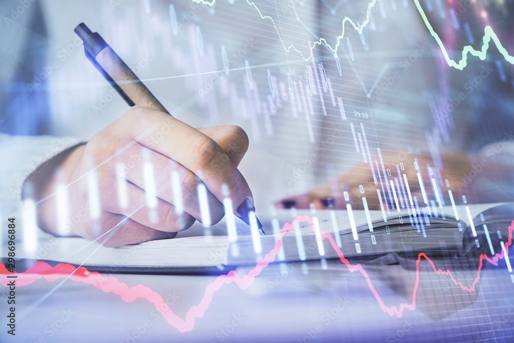 Multi exposure of woman's hands making notes with forex graph hologram. Concept stock market analysis. Multi exposure of woman's hands making notes with forex graph hologram. Concept stock market analysis.