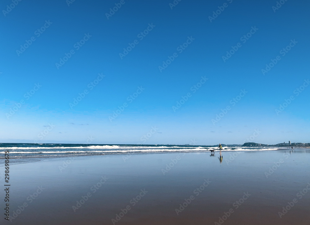 Beautiful wide panoramic view of  Surfers Paradise beach with rolling waves of Pacific ocean on Gold Coast, Australia.