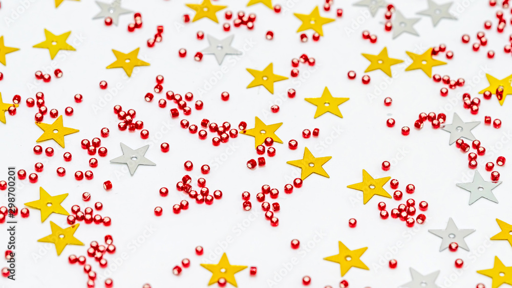 Christmas composition decoration. Pattern made of silver and gold star, golden decorations and red berries on white background. Christmas composition decoration. Pattern made of silver and gold star, golden decorations and red berries on white background.