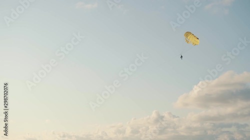 Parashute flying under the sea - Clouds and blue sky photo