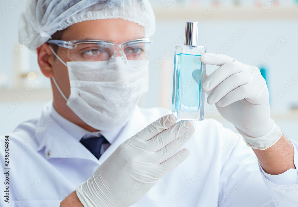 Chemist mixing perfumes in the lab Chemist mixing perfumes in the lab