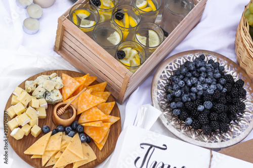 Flat lay Summer Picnic on the beach at sunset in the white plaid, food and drink conception. Top view