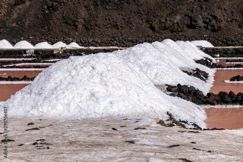 Salt piles and the different colours of water basins during the evaporation and salt collection process at Salinas de Fuencaliente, La Palma, Canary Islands, Spain photo