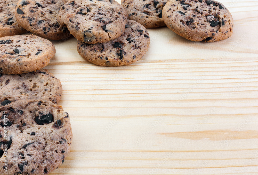 Tasty cookies with chocolate chips placed on a wooden background . Selective focus shot. Tasty cookies with chocolate chips placed on a wooden background . Selective focus shot.