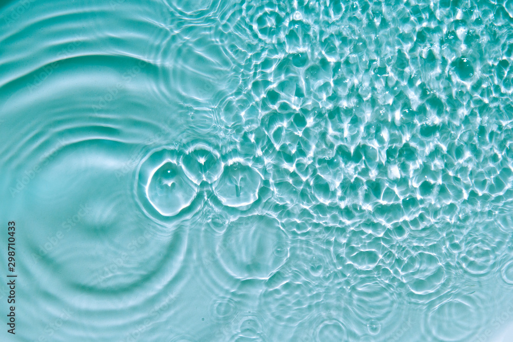 Water abstract background with blue rippled aqua texture, splash circle reflections in swimming pool. Top view Water abstract background with blue rippled aqua texture, splash circle reflections in swimming pool. Top view