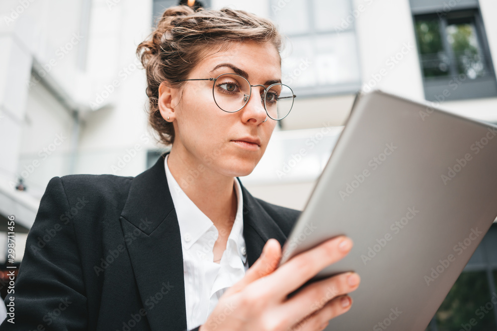 Businesswoman at cafe on veranda using gadgets for digital work. Young business woman sitting at coffee shop working on digital tablet. Businesswoman at cafe on veranda using gadgets for digital work. Young business woman sitting at coffee shop working on digital tablet.