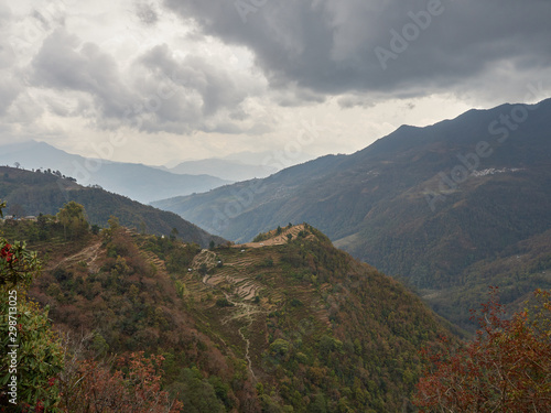 Harvested rice terraces on a hill in a remote village in the Himalayas. Cloudy autumn day. Nepal. © Maksim