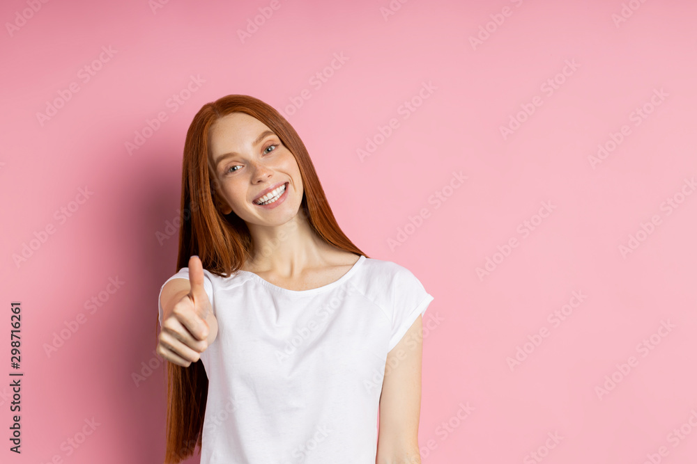 Portrait of young happy redhead woman in white t shirt Portrait of young happy redhead woman in white t shirt