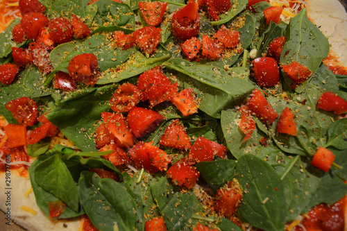 Close Up Background Texture With Sliced Cherry Tomatoes and Leafy Green Spinach