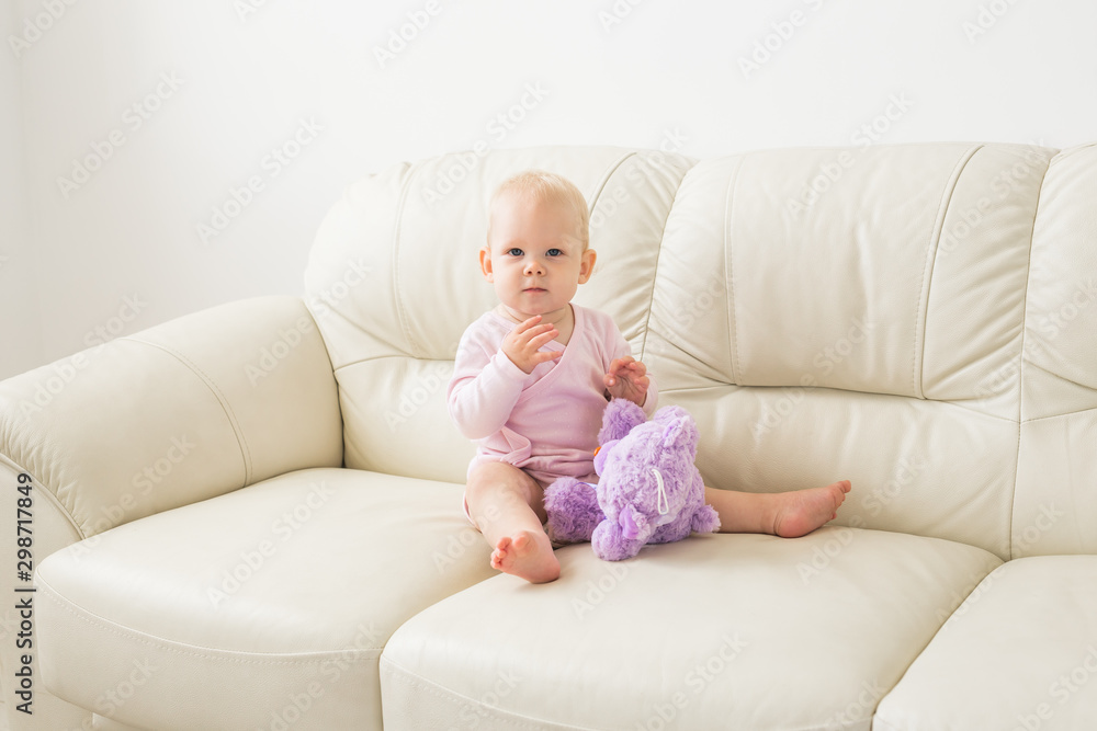 Child, childhood and kids concept - beautiful smiling baby sitting Child, childhood and kids concept - beautiful smiling baby sitting