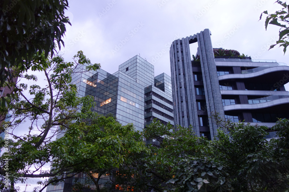 large glaß building next to luxury hoten in taipei city