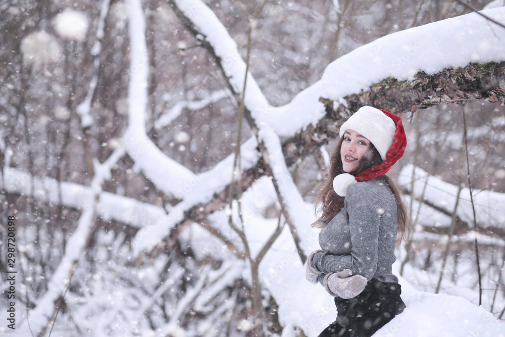 Girl in a winter park in snowfall Girl in a winter park in snowfall