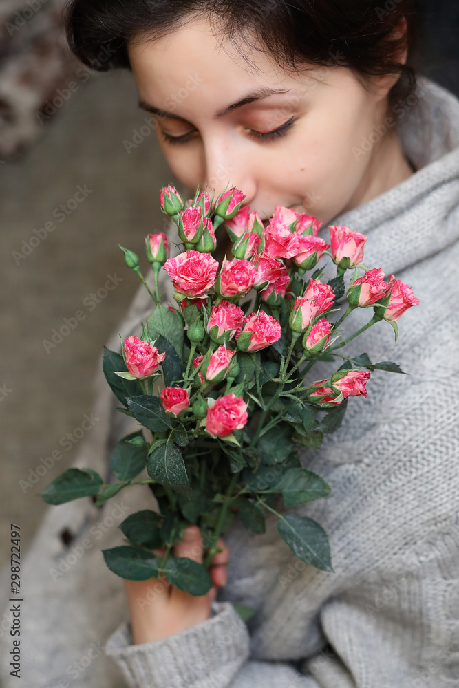bouquet of bush of roses in female hands on a background bouquet of bush of roses in female hands on a background
