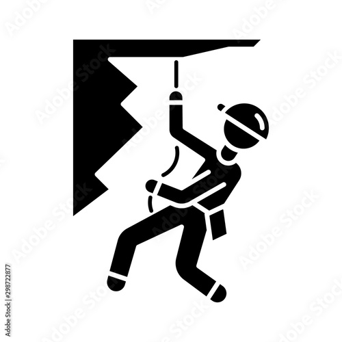 Mountain climbing glyph icon. Alpinism, mountaineering. Abseiling, rappelling descend. Spelunking. Mountaineer sliding down rope. Silhouette symbol. Negative space. Vector isolated illustration