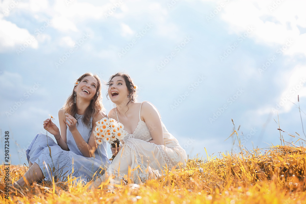 Two girls in dresses in autumn field Two girls in dresses in autumn field