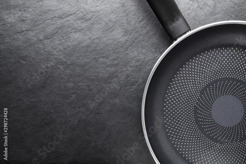 Black skillet with non-stick surface on slate background photo
