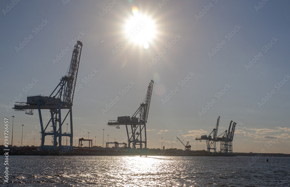 Back lit Cranes in port