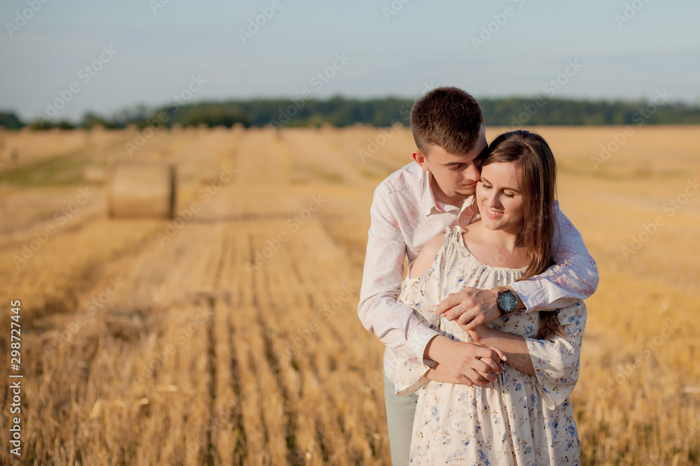 Happy young couple on straw, romantic people concept, beautiful landscape, summer season