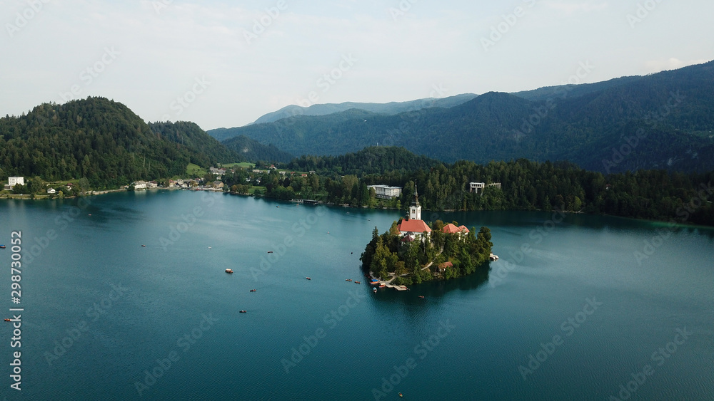 Lake Bled Slovenia. Beautiful mountain lake with small Pilgrimage Church. Most famous Slovenian lake and island Bled with Pilgrimage Church of the Assumption of Maria and Bled Castle in background. Lake Bled Slovenia. Beautiful mountain lake with small Pilgrimage Church. Most famous Slovenian lake and island Bled with Pilgrimage Church of the Assumption of Maria and Bled Castle in background.
