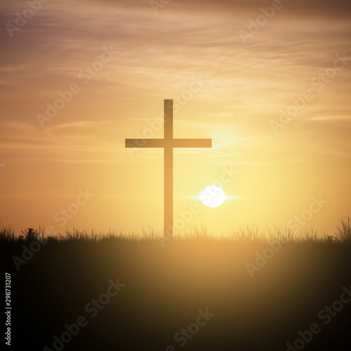 christian cross at sunset sky