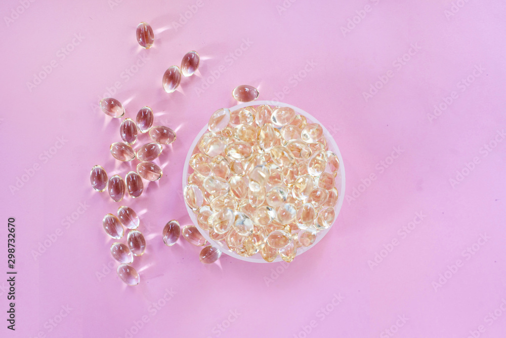 Omega 3 fish oil capsules healthy lifestyle pink background Omega 3 fish oil capsules healthy lifestyle pink background