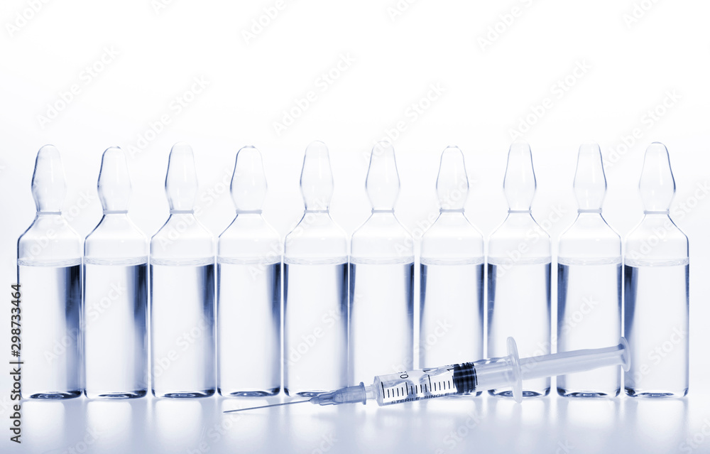 Glass medicine ampoules and Syringe on white background Glass medicine ampoules and Syringe on white background
