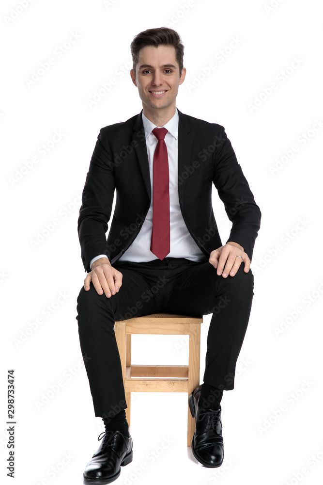 Positive businessman looking forward and smiling Positive businessman looking forward and smiling