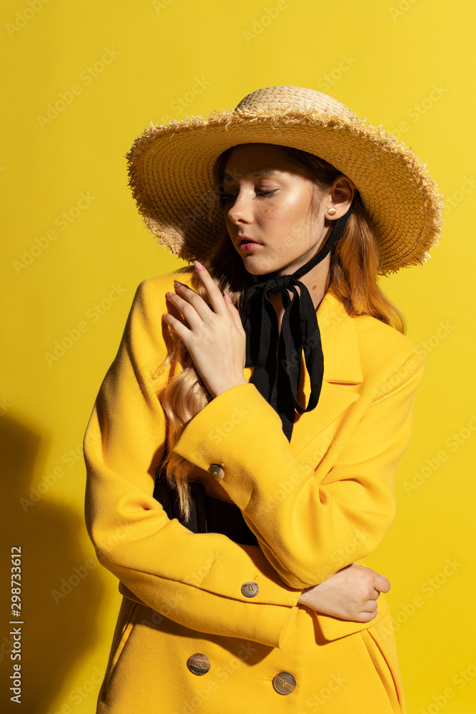 Pretty blonde girl with freckles in yellow outfit and straw hat Pretty blonde girl with freckles in yellow outfit and straw hat