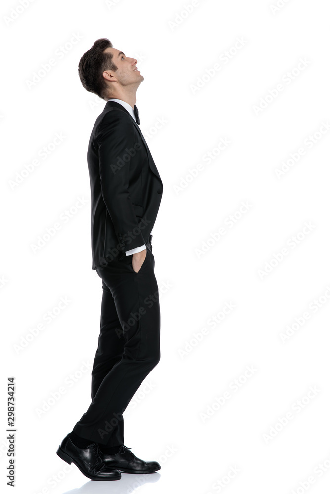 side view of young elegant model walking and looking up side view of young elegant model walking and looking up