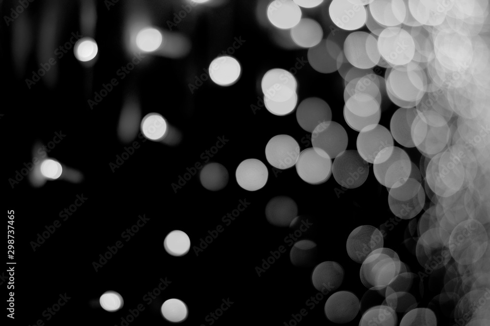 Abstract background of light white bokeh on a black night background. Abstract background of light white bokeh on a black night background.