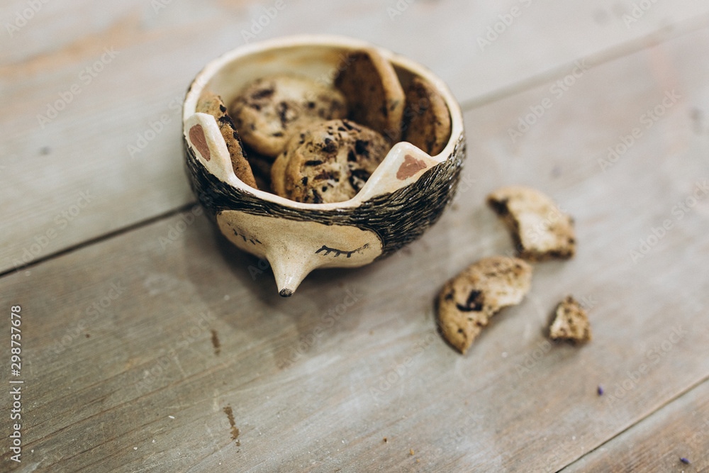 Handmade dishes with cookies on wooden table. Ceramist concept Handmade dishes with cookies on wooden table. Ceramist concept