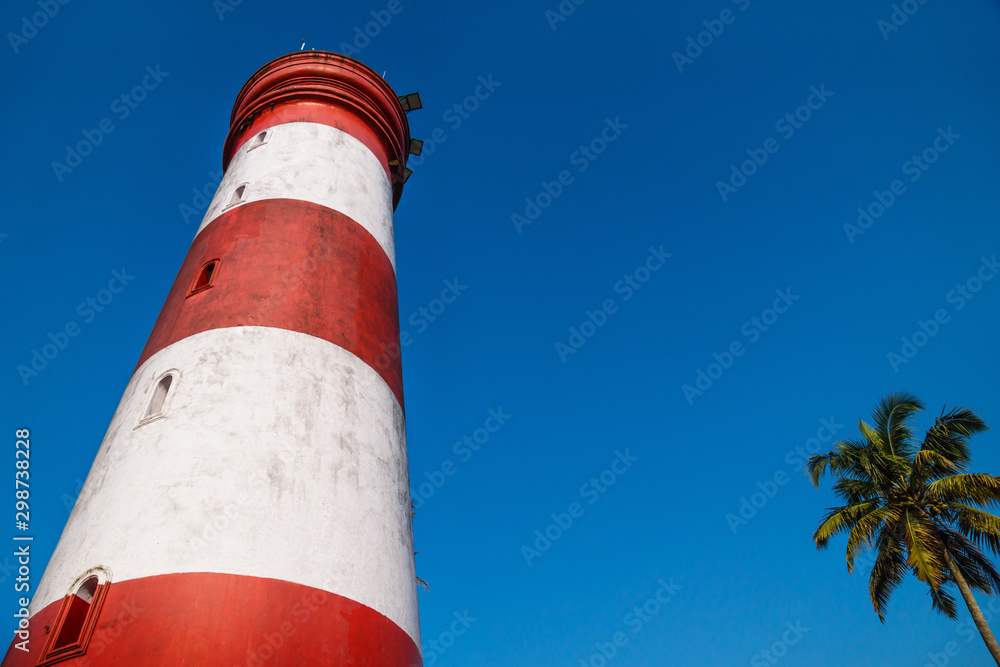 Low angle view of Alleppey Lighthouse with red and white stripes, Aleppuzha, Kerala, India