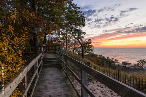 wooden path overlooking sunset at sea